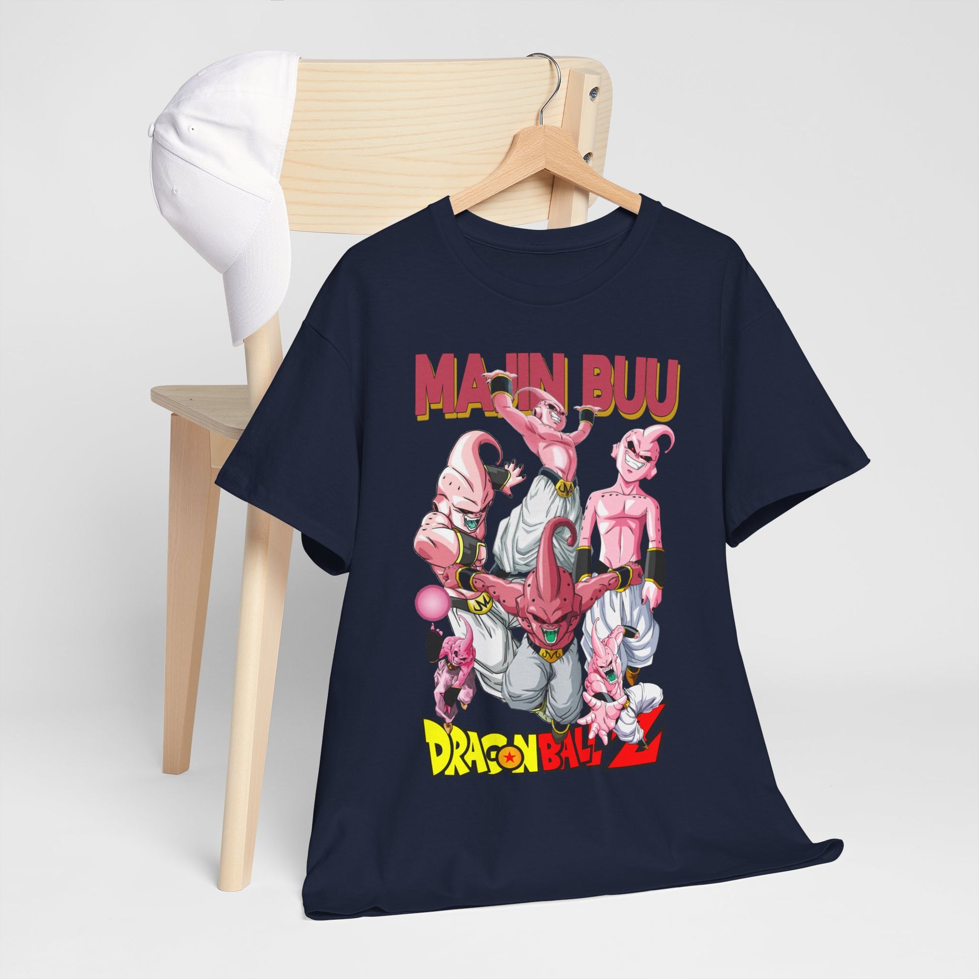 Majin Buu graphic t-shirt elegantly draped on a chair alongside a white cap, featuring intricate anime illustrations in vibrant hues that celebrate anime culture.