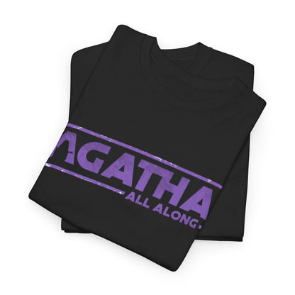 Folded Agatha All Along Unisex T-Shirts in black with vibrant purple print, ideal for those who appreciate clever and humorous graphic wear, combining style and personality.