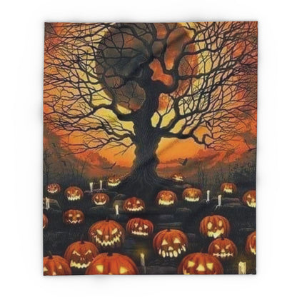 Decorative and Warm Halloween Spooky Arctic Fleece Blanket showcasing a captivating display of glowing jack-o'-lanterns beneath a gnarled tree silhouette at twilight.