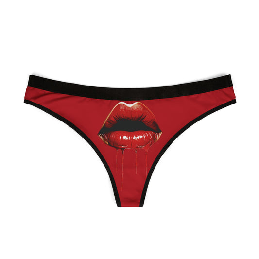 Stylish women’s thong featuring striking red lips graphic on a vivid background, ideal for cheeky gifts and intimate moments.