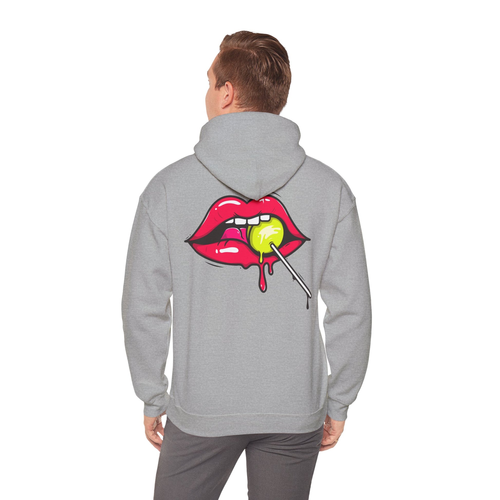 A man wearing a sophisticated grey hoodie with a playful design of red lips and a lollipop, reflecting modern luxury in casual wear.