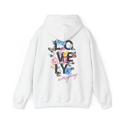 Elegant white hoodie featuring a vibrant floral graphic on the back, showcasing the word 'LOVELY' in bold dark-gray letters, complemented by delicate pink roses, blue daisies, and fluttering butterflies, perfect for stylish casual wear.