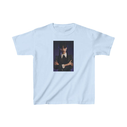 Child's 'Wednesday': Embrace the Dark Elegance! Graphic Unisex Tee in light blue featuring a striking image of a young girl with dark hair styled in pigtails, wearing a dark striped jacket, embodying the gothic allure of Wednesday Addams.