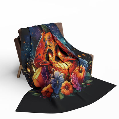Decorative and Warm Halloween Spooky Arctic Fleece Blanket, elegantly draped over a chair, featuring an intricate skull design surrounded by flowers and stars, ideal for enhancing your Halloween festivities with sophisticated warmth.