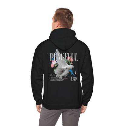 Stylish back view of a black hoodie featuring a serene dove and rose graphic, with the word 'PEACEFUL' and '1980' emblazoned in elegant typography.