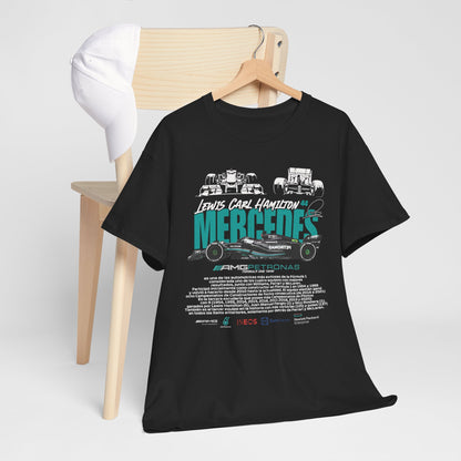 Luxury Mercedes F1 Tribute Tee featuring Lewis Hamilton's name and iconic car graphics, displayed on a minimalist setting with a cap and wooden chair.