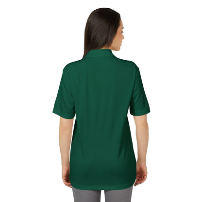 Back view of a female model in the Adidas Unisex Performance Polo Shirt, demonstrating comfort and sustainability in a stylish green hue.