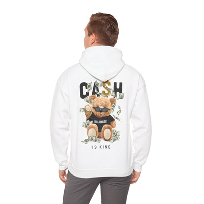 Man wearing a trendy white hoodie featuring a fun teddy bear graphic with dollar bills and the phrase 'CASH IS KING', stylishly highlighting casual elegance.