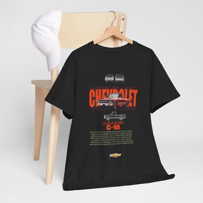 Black t-shirt draped over a wooden chair, featuring a striking Chevrolet C-10 vintage design with detailed graphics and bold lettering, combining comfort and style for car enthusiasts.
