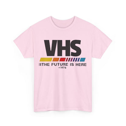 VHS Retro Logo Graphic Tee for Unisex | Soft cotton fabric t-shirt in pastel pink featuring a nostalgic VHS design with vibrant colours and the phrase 'THE FUTURE IS HERE 1976', ideal for vintage lovers.