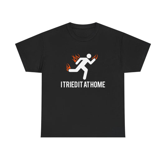 Luxury black mens t-shirt featuring a minimalist stick figure running design with vivid flames and the empowering phrase 'I TRIED IT AT HOME' highlighting movement and motivation.