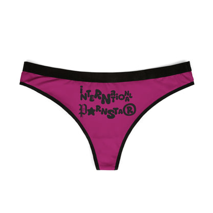 Front view of a stylish cheeky thong showcasing the unique 'International Star' design in bold lettering, set against a vibrant magenta background.