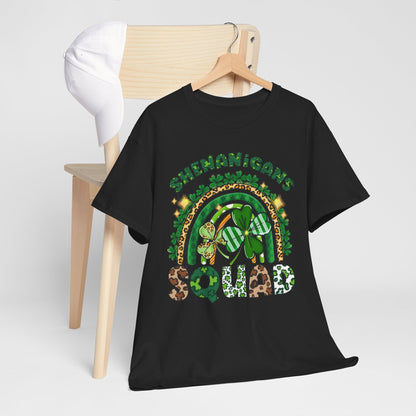St Patricks Day Unisex Men's Women's Graphic Cotton Funny T Shirt Tee Vintage styled on a wooden chair, displaying the whimsical 'Shenanigan's Squad' design with green hues and playful patterns.