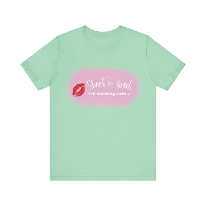 Sabrina Carpenter Inspired Unisex Short Sleeve Tee in mint green adorned with a vibrant lipstick print and the phrase 'Short n sweet, I'm working late...', combining luxury and effortless style.