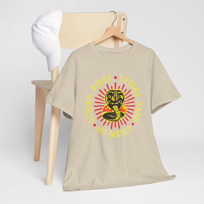 Chic Cobra Kai t-shirt laid casually on a chair next to a white cap, emphasising a trendy, relaxed style while celebrating martial arts culture.