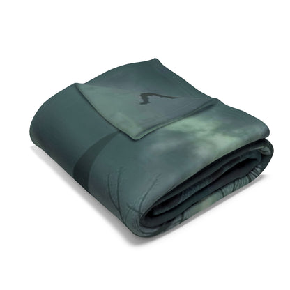Chic, folded decorative and warm Halloween Arctic fleece blanket, featuring a dark, brooding design ideal for sophisticated autumn evenings and luxury decor.