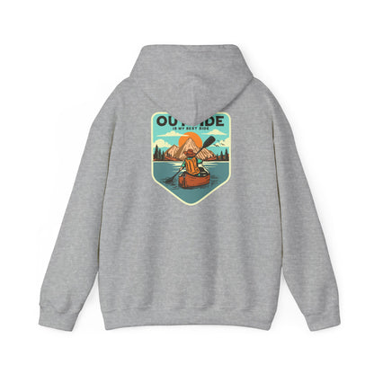 Elegant grey hoodie featuring a retro graphic of a kayaker amidst mountains and a serene lake, accompanied by the phrase 'OUTSIDE IS MY BEST SIDE'.
