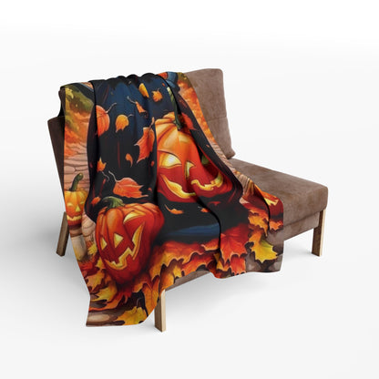 Luxurious Decorative and Warm Halloween Spooky Arctic Fleece Blanket draped elegantly over a stylish armchair, featuring vibrant jack-o'-lantern designs amongst autumn leaves.