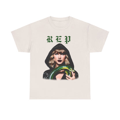 Taylor Swift Reputation Era unisex cotton t-shirt in cream displaying an enchanting graphic of Taylor Swift in a black glittery hooded outfit, embracing a green snake, tailored for Swifties. Available in 8 colours.