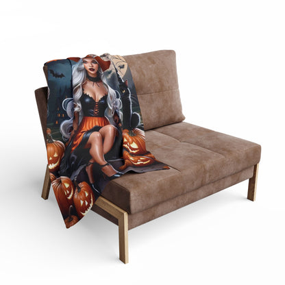 Contemporary Decorative and Warm Halloween Spooky Arctic Fleece Blanket draped over a stylish sofa, featuring a striking witch and orange pumpkins, creating a luxurious Halloween atmosphere.