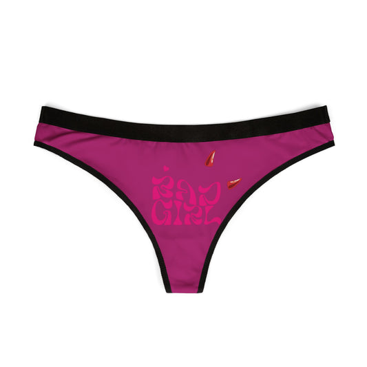 Front view of the 'Bad Girl' thong showcasing the striking hot pink fabric and playful devil horns, perfect for adding a daring touch to lingerie collections.