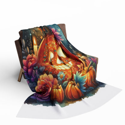 Chic Arctic fleece blanket draped over a chair, displaying a stunning skull and floral artwork, the perfect addition for Halloween luxury.