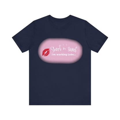 Sabrina Carpenter Inspired Unisex Short Sleeve Tee in navy, embellished with a vibrant lipstick print and the phrase 'Short 'n sweet i'm working Late...', exuding chic elegance.