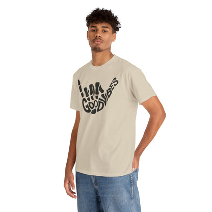 A fashionable young man wearing a high-quality t-shirt with a unique 'Good Vibes' skeletal hand gesture, epitomizing effortless style and positive energy.