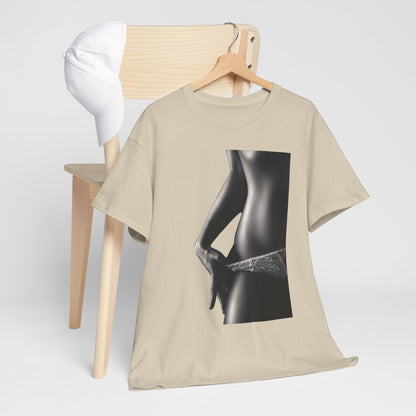 Stylish beige cotton tee artfully placed on a wooden chair beside a white cap, featuring a captivating monochrome print of a feminine form.