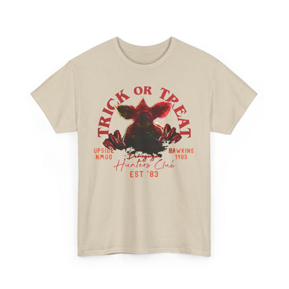 Chic graphic tee featuring a detailed Demogorgon motif complemented by 'TRICK OR TREAT' and vintage-inspired phrases, embodying the spirit of the Upside Down in a luxurious fashion statement.