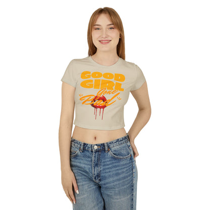 Woman modelling the Good Girl Gone Bad cropped tee in beige, showcasing bold typography and a graphic of red lips, paired with high-waisted jeans for a trendy look.