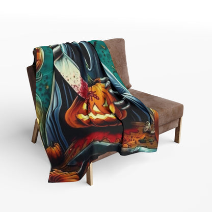 Decorative and Warm Halloween Spooky Scream Arctic Fleece Blanket draped over a rustic chair, featuring vividly illustrated Halloween elements including a bloodied knife and a pumpkin.