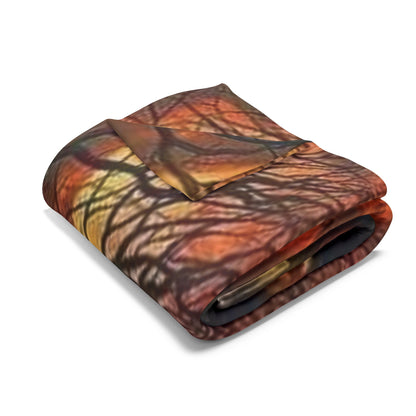 Decorative and Warm Halloween Spooky Arctic Fleece Blanket folded elegantly, displaying the intricate design of a dark, twisted tree and fiery autumn hues.