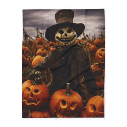 Chic Decorative and Warm Halloween Spooky Arctic Fleece Blanket presenting a scarecrow with a haunting grin in a field of pumpkins, perfect for a sophisticated Halloween setting.