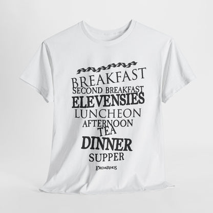 Elegant white graphic t-shirt featuring humorous Hobbit meal names from Lord of the Rings, including 'Breakfast,' 'Second Breakfast,' and 'Supper,' presented in artistic typography.