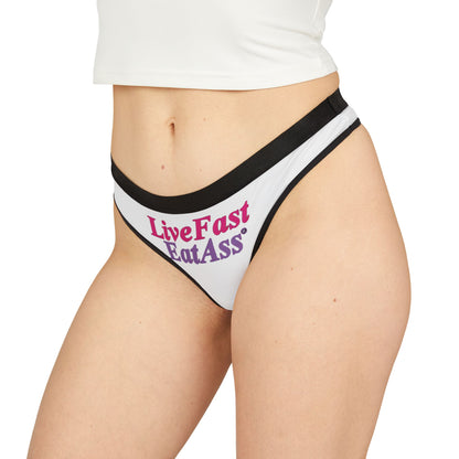 Elegant model showcasing the 'Live Fast Eat Ass' thong panties, featuring a bold graphic design, perfect for expressing confidence and individuality in luxury lingerie.