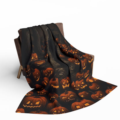 Elegant Halloween Arctic fleece blanket draped over a chair, showcasing vibrant jack-o'-lantern designs, perfect for adding a touch of seasonal charm to your Halloween decor.