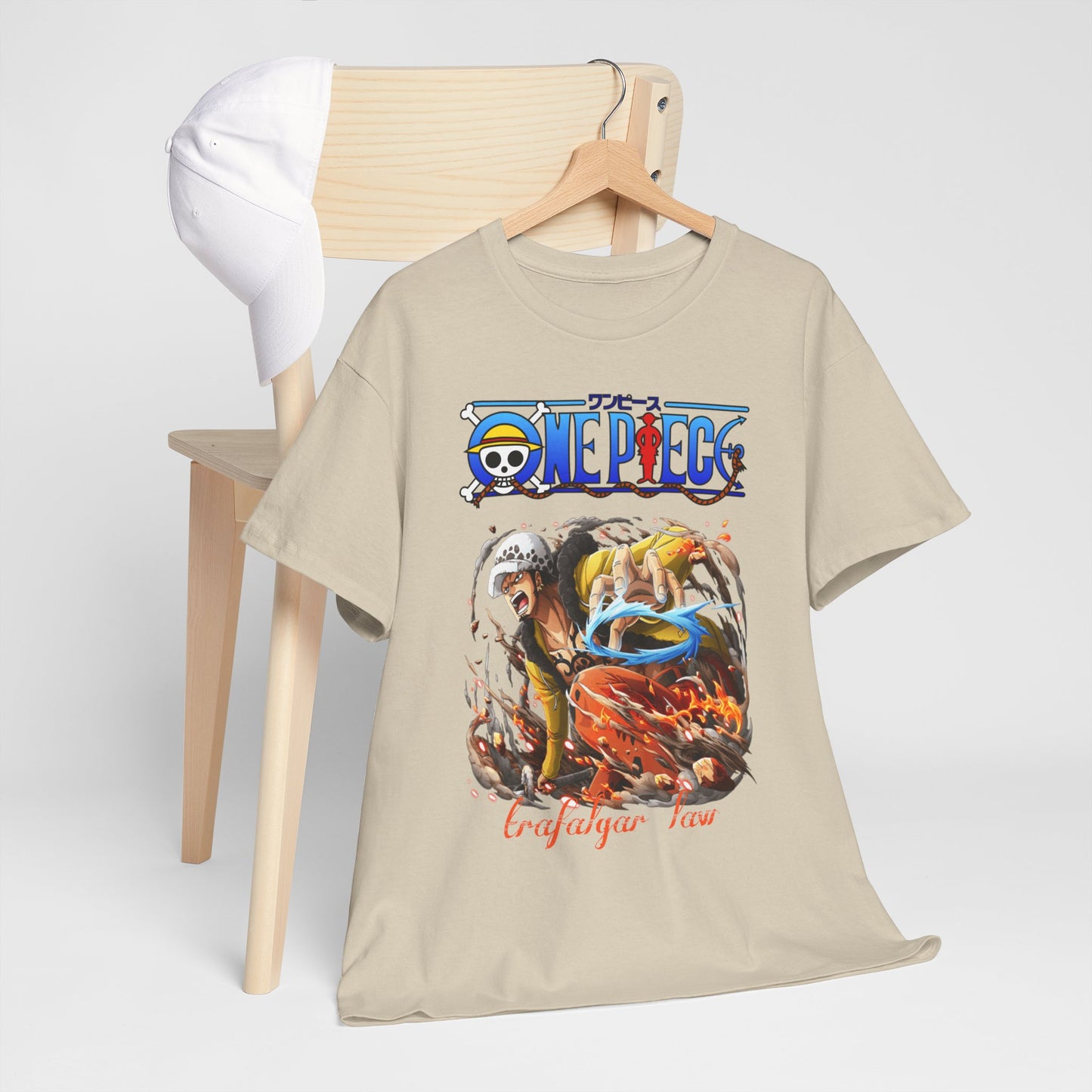 Stylish One Piece t-shirt elegantly displayed on wooden chair with a matching cap, showcasing the striking Trafalgar Law design, ideal for casual luxury.