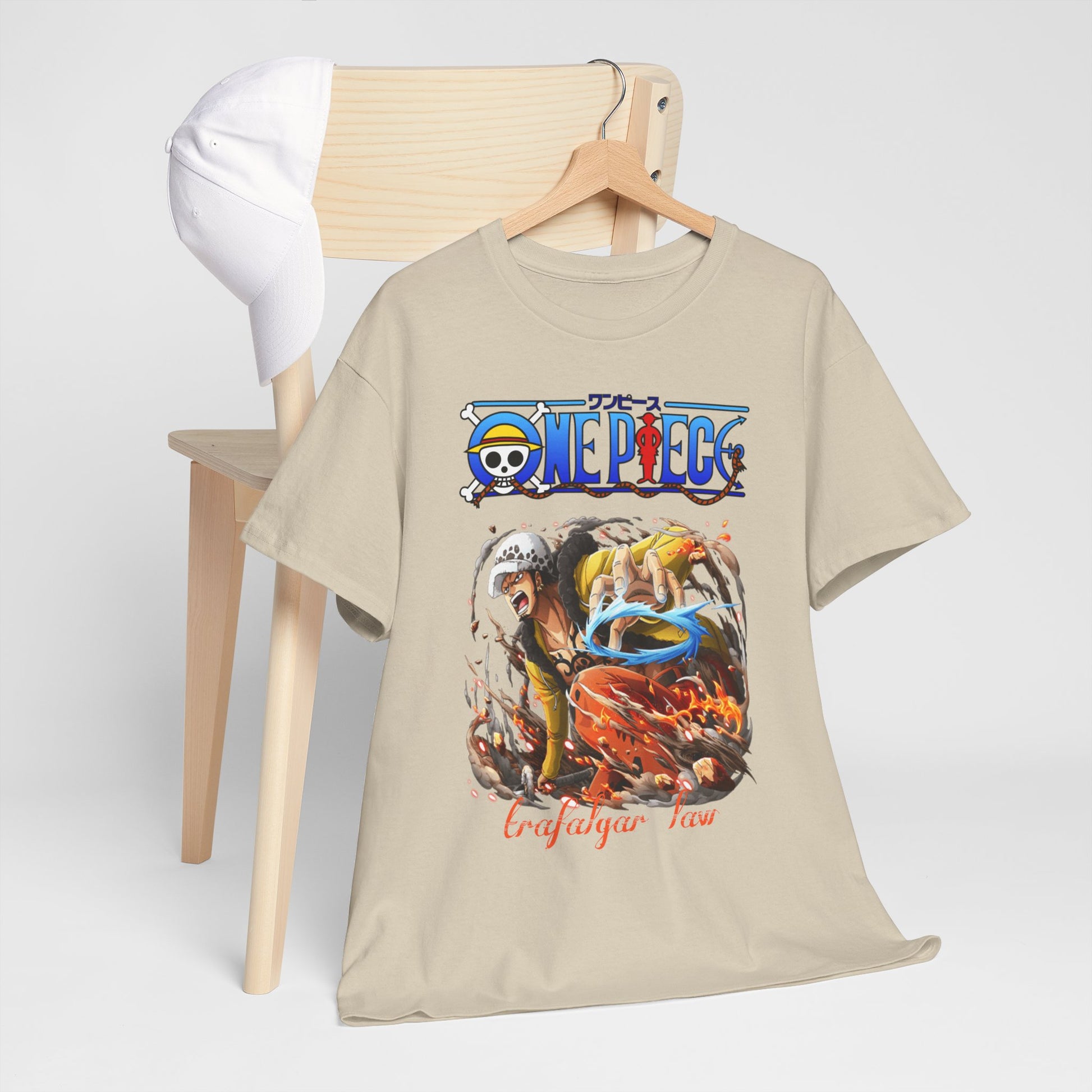 Stylish One Piece t-shirt elegantly displayed on wooden chair with a matching cap, showcasing the striking Trafalgar Law design, ideal for casual luxury.