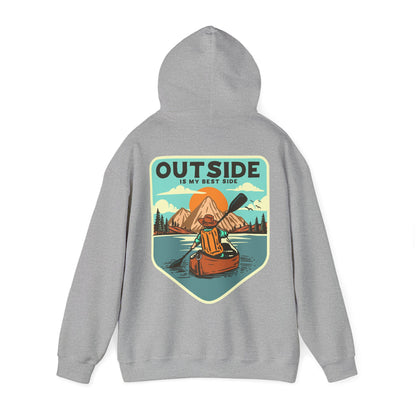 Premium grey hoodie with a vintage style graphic depicting a serene kayaking scene, illustrating the essence of adventure and the phrase 'OUTSIDE IS MY BEST SIDE'.