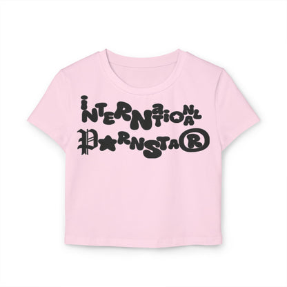 Sophisticated pink cropped baby T-shirt featuring the playful graphic text 'INTERNATIONAL PARNSTAR' in bold black font, perfect for a fun and stylish wardrobe.