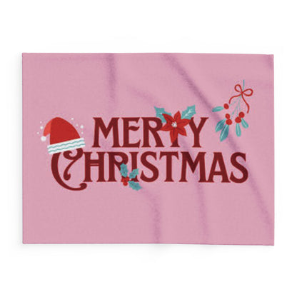 Decorative and Warm Christmas Arctic Fleece Blanket featuring vibrant 'Merry Christmas' lettering with festive motifs including a Santa hat and poinsettias on a pink background.