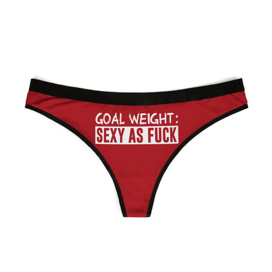 Chic red women's thong with black elastic waistband, showcasing playful text: 'GOAL WEIGHT: SEXY AS FUCK', perfect for adding a touch of fun to intimate wear.