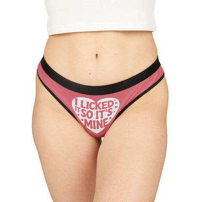 Elegant women's thong featuring a playful heart graphic with the phrase 'I Licked It So It’s Mine' in bold lettering, designed for a cheeky Valentine's Day gift or romantic occasion.
