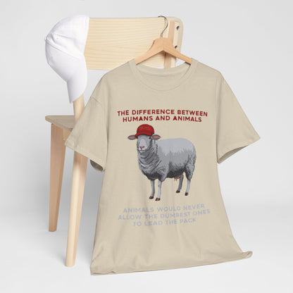Chic T-shirt draped elegantly over a chair, depicting a sheep in a red cap with the phrase 'THE DIFFERENCE BETWEEN HUMANS AND ANIMALS', perfect for discerning individuals seeking to express individuality.
