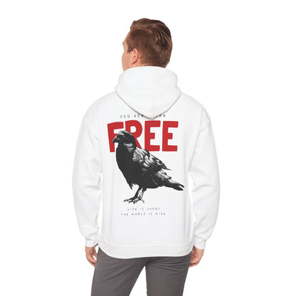Man wearing a chic white hoodie with a striking raven graphic and bold typography that reads 'YOU WERE BORN FREE', exuding a sense of freedom and individualism.