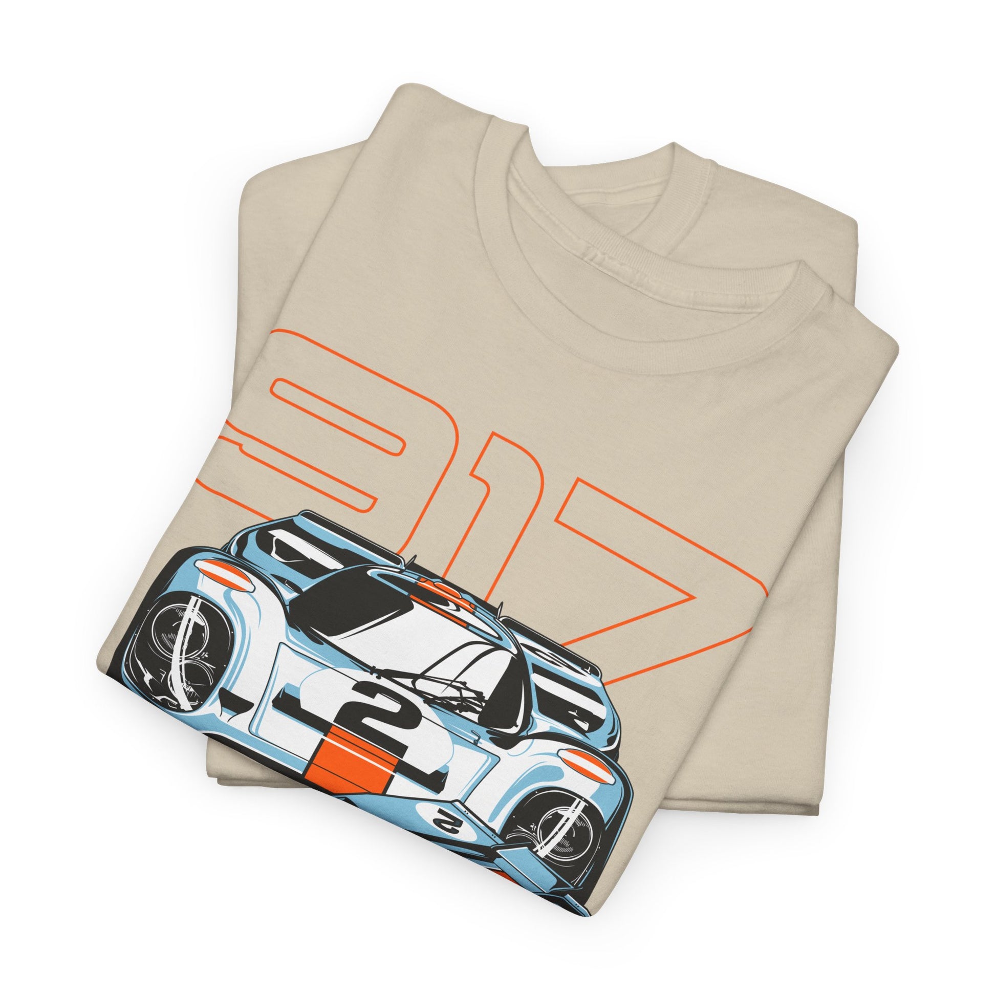 Stylishly folded beige t-shirt displaying a bold Porsche 917 graphic, featuring a prominent orange '917' and intricate car illustrations.
