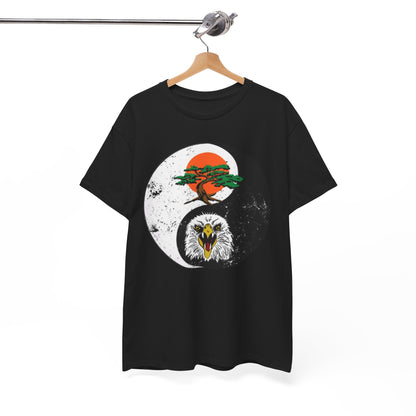 Sophisticated black graphic t-shirt elegantly hung on a wooden hanger, showcasing a captivating yin-yang illustration featuring a bonsai tree and a powerful eagle, perfect accessory for martial arts fans.