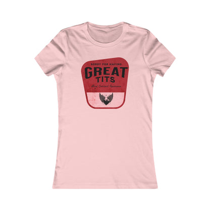 Elegant women's graphic t-shirt in soft pink featuring a bold retro-inspired design with the phrase "SORRY FOR HAVING GREAT TITS" atop a striking red background, embodying empowerment and humour.