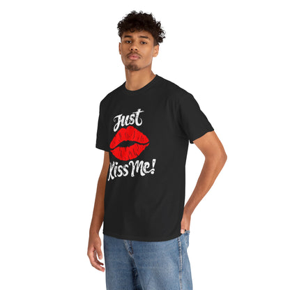 A fashionable young man wearing a black cotton t-shirt adorned with a striking graphic of red lips and the phrase 'Just Kiss Me!', embodying a chic and playful style.